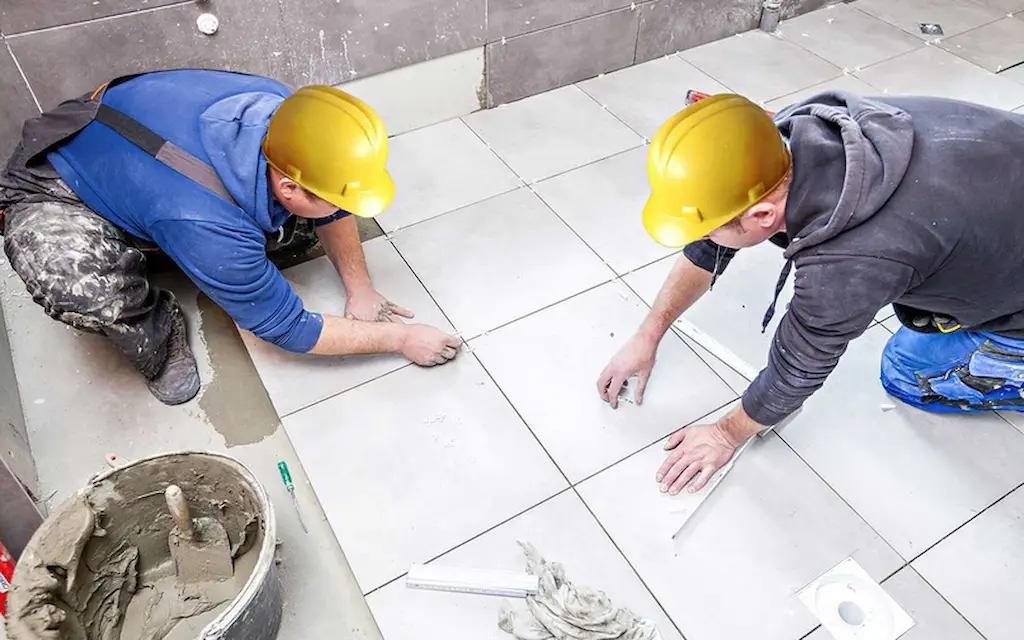 two men are working on Tile Fixing service in Dubai