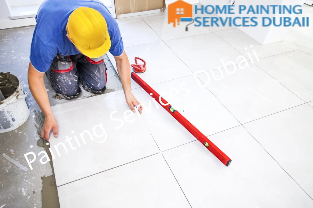 A man working on Tile Fixing service for fixing floor tiling Dubai